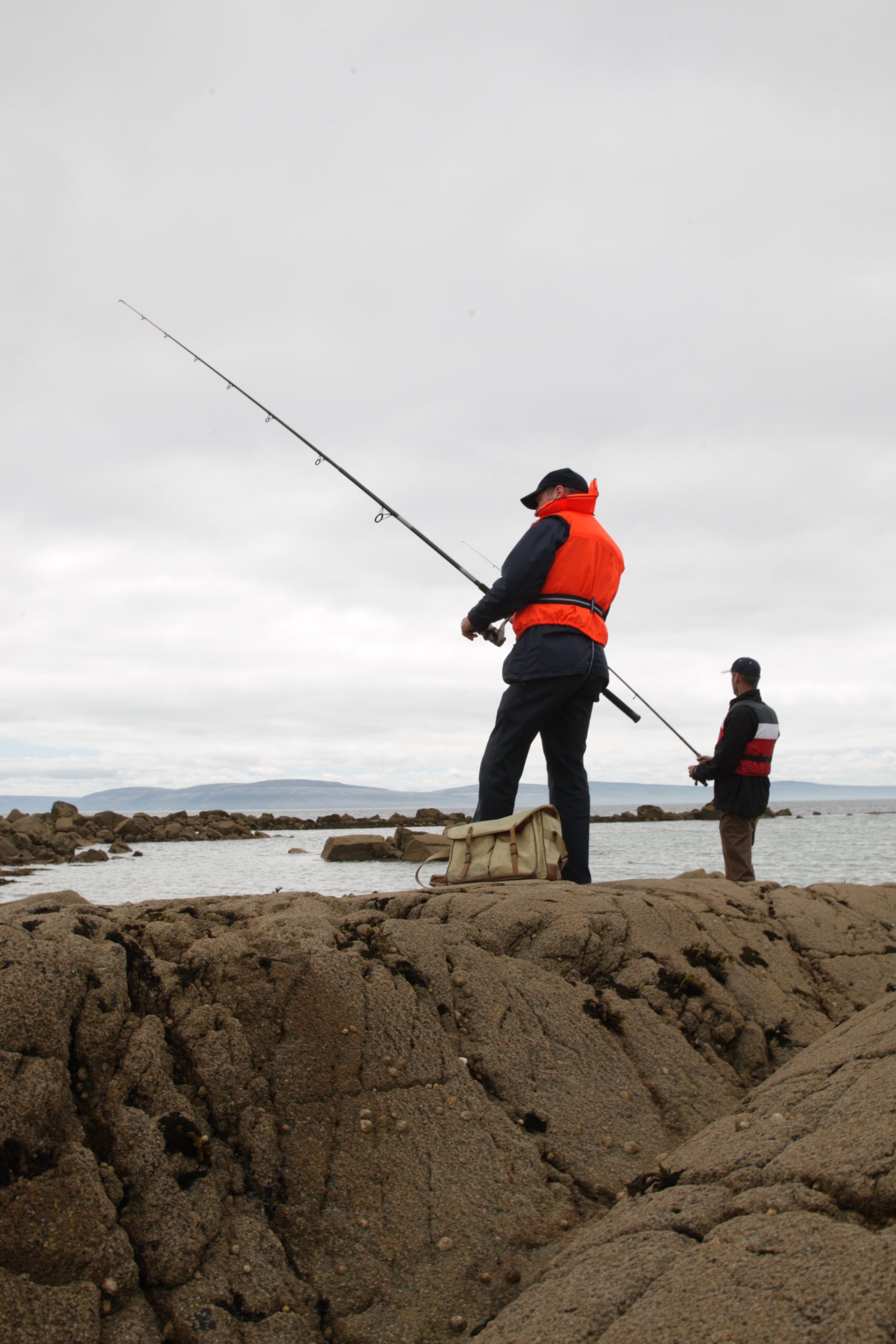 Person fishing wearing a life vest