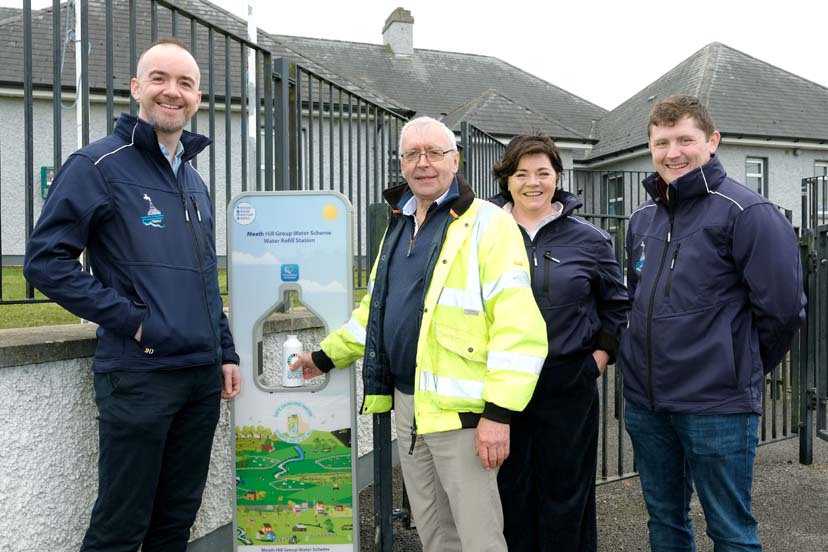 Newly installed water refill station with people gathered around it