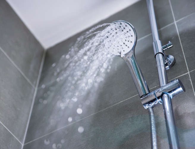 Shower head with water coming out.